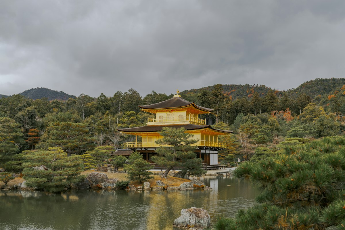 Kinkaku-ji, the Golden Pavilion in Kyoto, framed by autumn trees